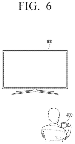 Person holds cup at smart TV., drawing sheet 6 from US 2026/0259657 A1