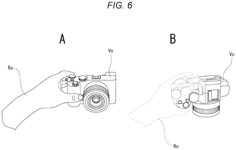 Hand gripping a virtual camera., drawing sheet 6 from US 2026/0289920 A1